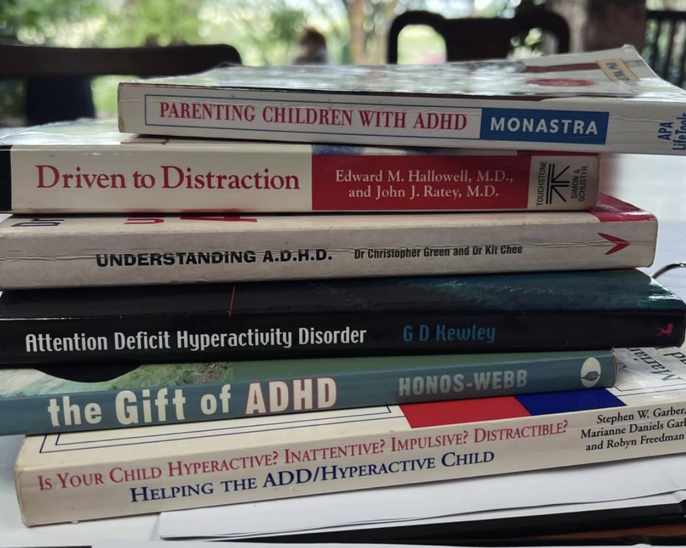 A stack of well-read books about ADHD and parenting children with ADHD